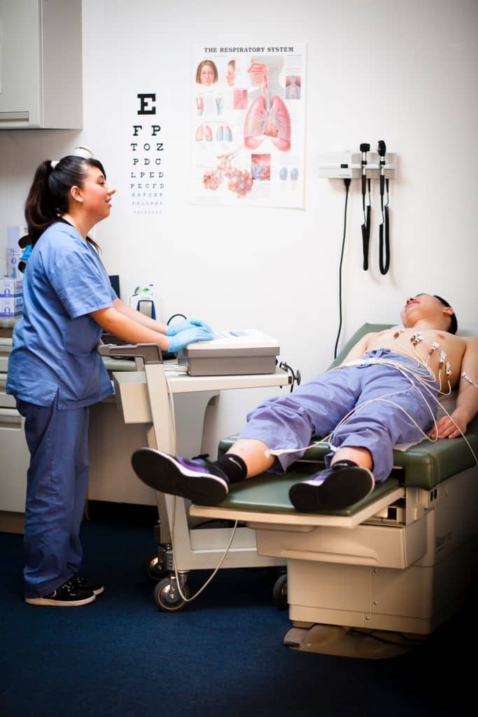 A BAMA student practicing an electrocardiogram.