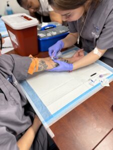 Phlebotomy-Was it? Here phlebotomy students can be seen drawing blood.