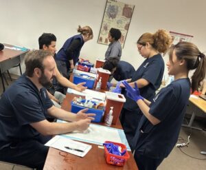 Students training for phlebotomy jobs